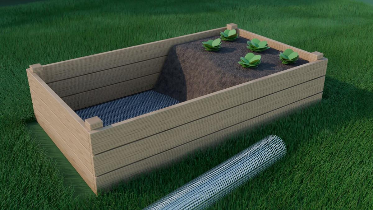 Wooden raised garden bed lined with stainless steel wire mesh, half filled with soil, a roll of mesh beside it