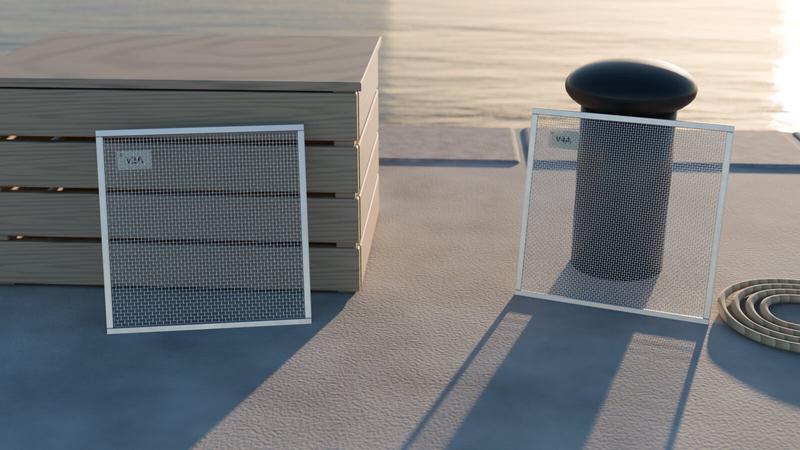Two framed stainless steel wire mesh samples labelled V2A and V4A on a harbour quay at sunset